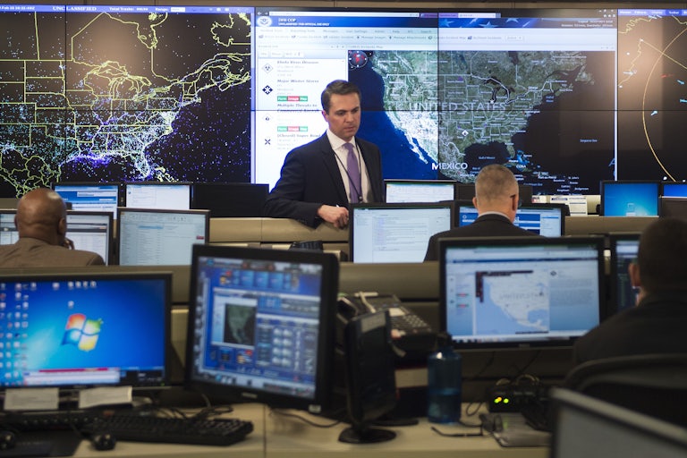 Federal employees in a room with several computers