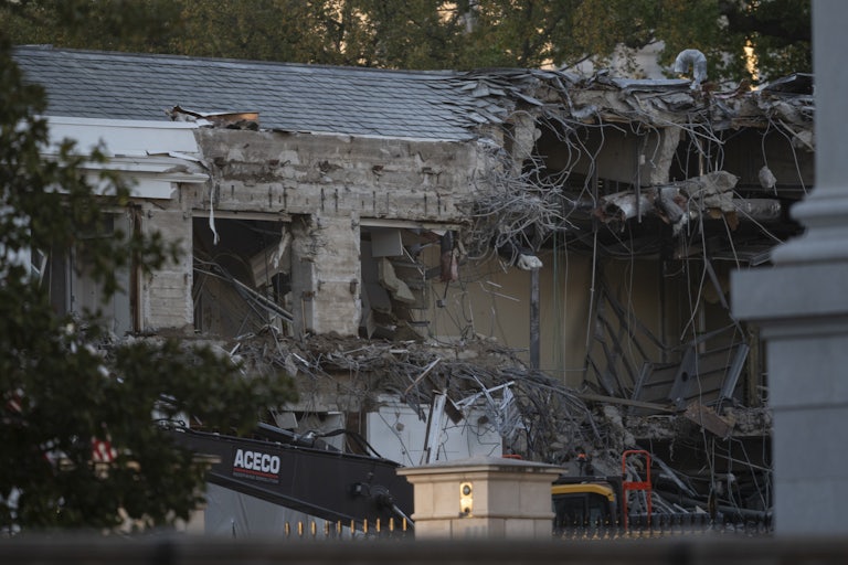 A photo of the torn down East Wing of the White House, with crubmling stones and roofing