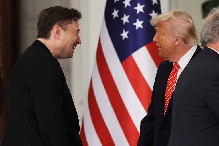Elon Musk speaks and laughs with Donald Trump at the royal palace in Qatar