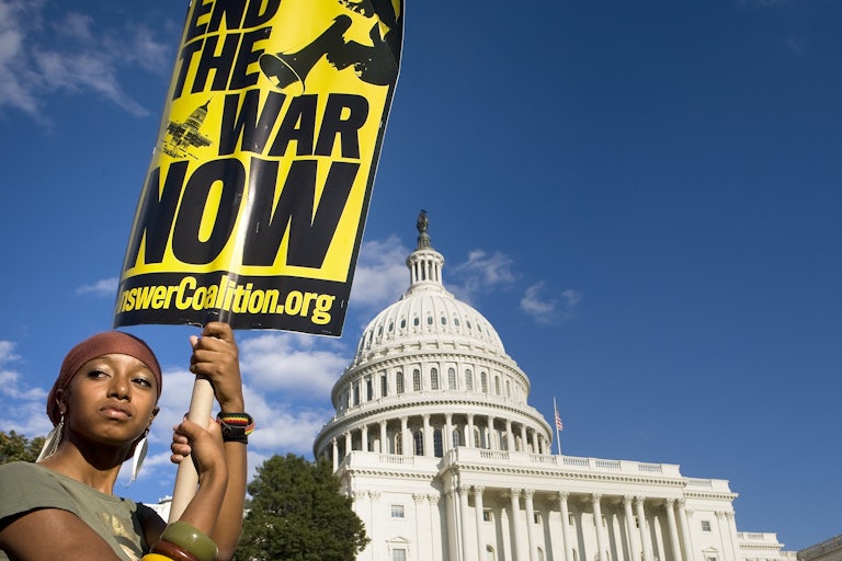 The sign reads: End the War Now.