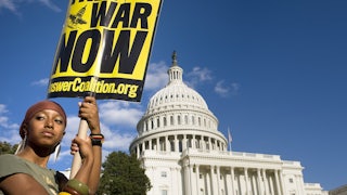 The sign reads: End the War Now.
