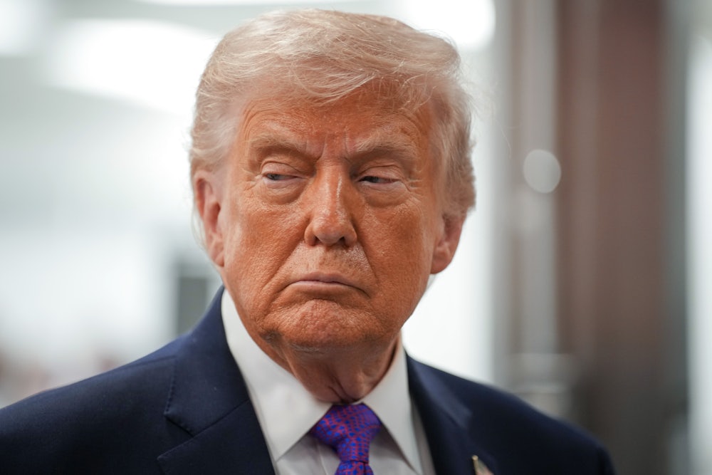 Donald Trump scowls while looking sideways to his right