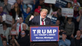 Donald Trump shakes his fist while speaking at a campaign rally.