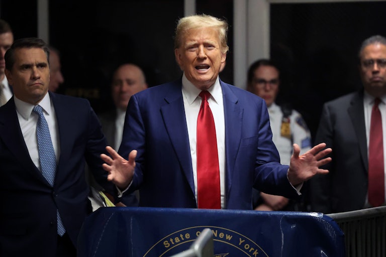 Donald Trump gestures with both hands as he speaks