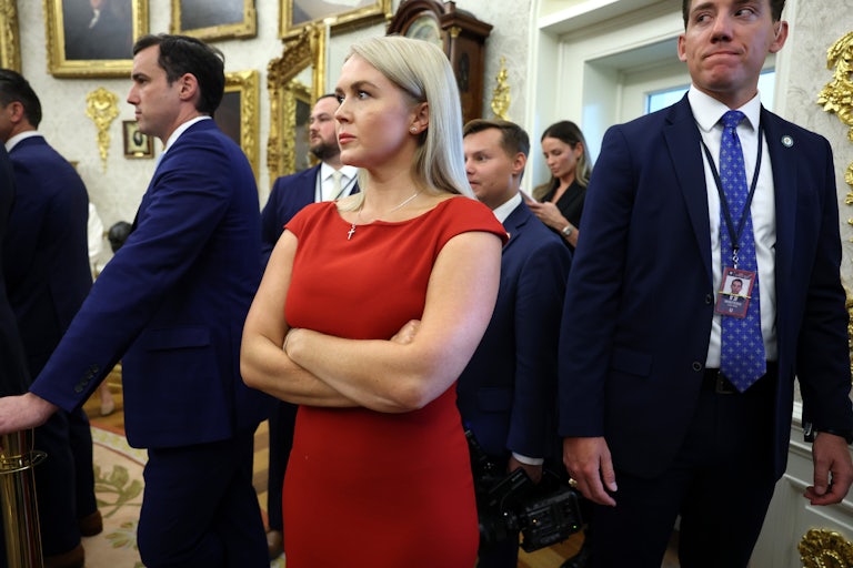 White House Press Secretary Karoline Leavitt listens as President Donald Trump and Ukrainian President Volodymyr Zelenskiy meet in the Oval Office..
