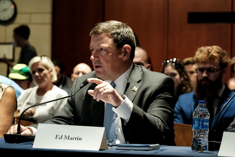 Ed Martin speaks during a congressional hearing, with a paper name tent in front of him