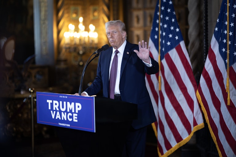 Donald Trump gestures while speaking at a podium