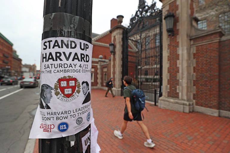 A piece of paper on a pole advertises a "Stand Up Harvard" protest on April 12.