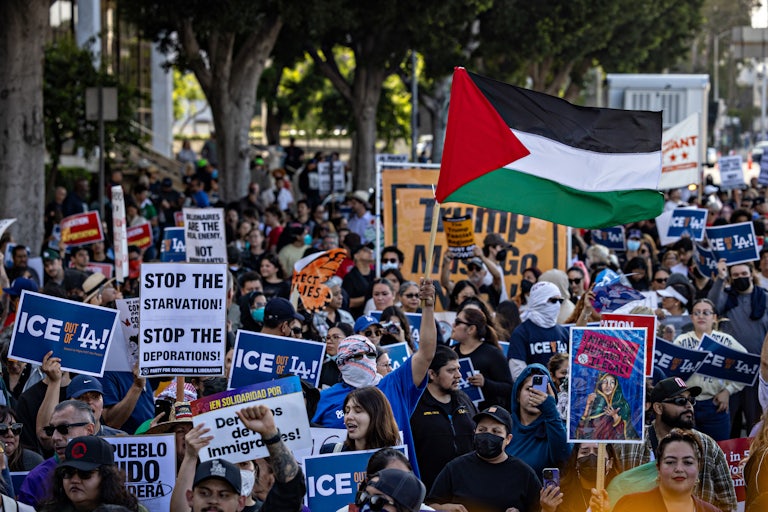 Protesters march through the streets of Los Angeles holding signs supporting immigrants and demanding ICE leave the city
