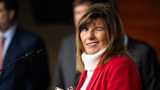 Representative Diana Harshbarger winks while standing at a podium