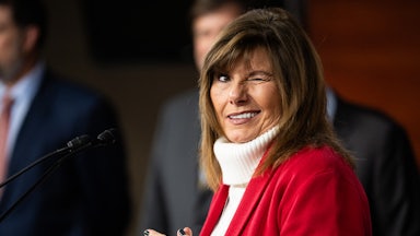 Representative Diana Harshbarger winks while standing at a podium