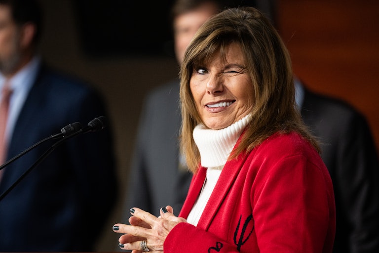 Representative Diana Harshbarger winks while standing at a podium