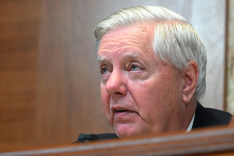 Senator Lindsey Graham looks up while sitting in a Senate hearing