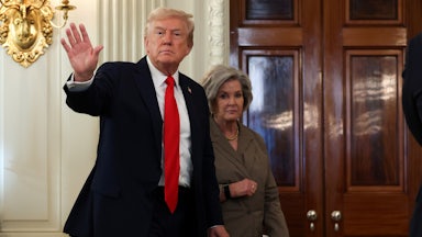 Donald Trump waves while walking in front of his chief of staff Susie Wiles