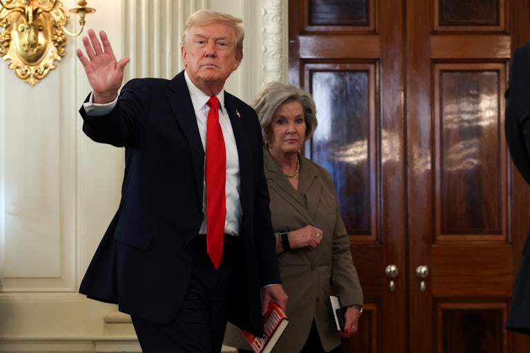 Donald Trump waves while walking in front of his chief of staff Susie Wiles