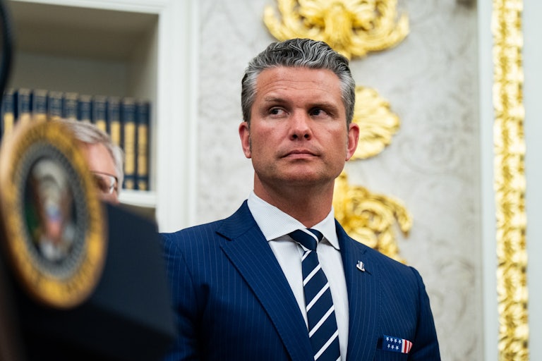 Defense Secretary Pete Hegseth stands in the Oval Office.