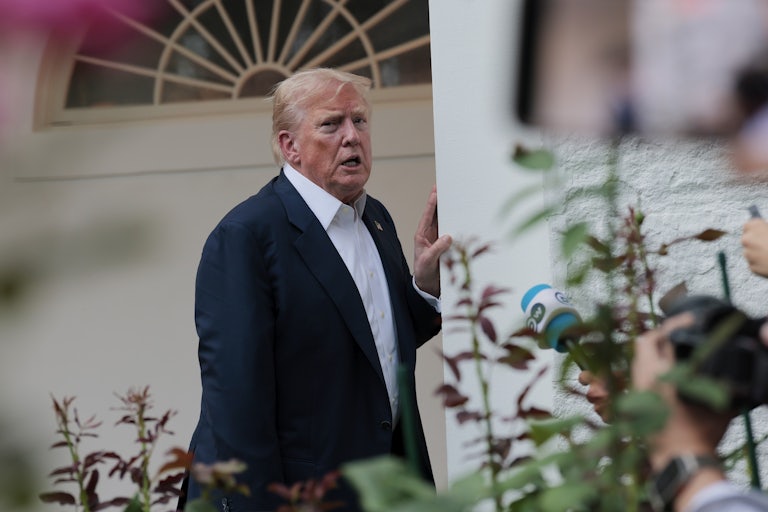 Donald Trump speaks to reporters near the Rose Garden in the White House. He seems stressed and/or tired.