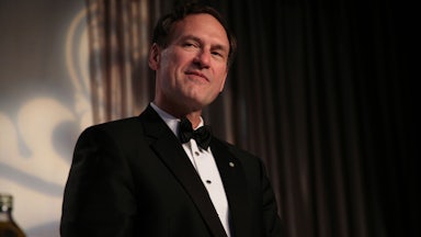 A tuxedo-clad Samuel Alito smirks.