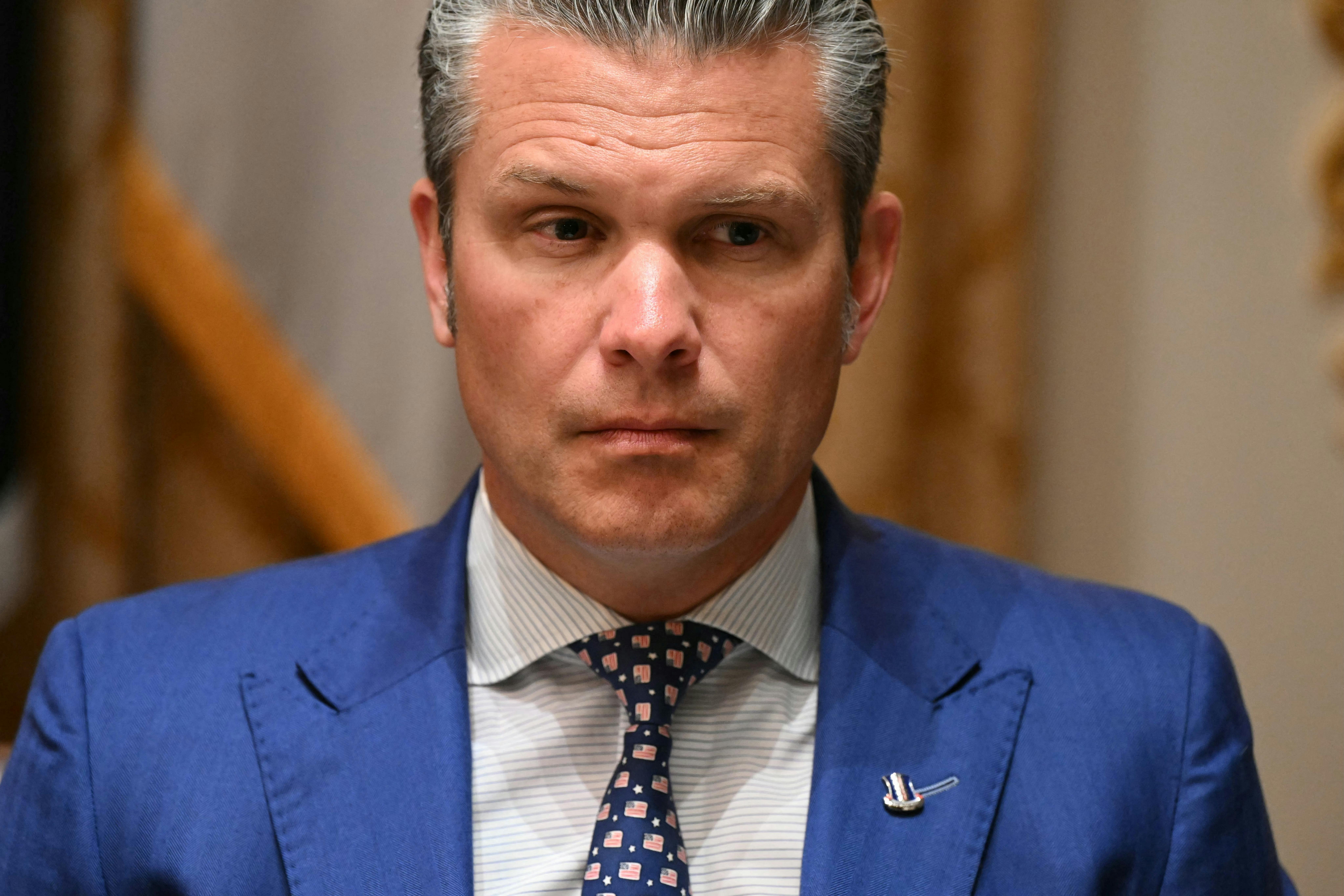 Defense Secretary Pete Hegseth sits during a meeting between Donald Trump and the Australian prime minister