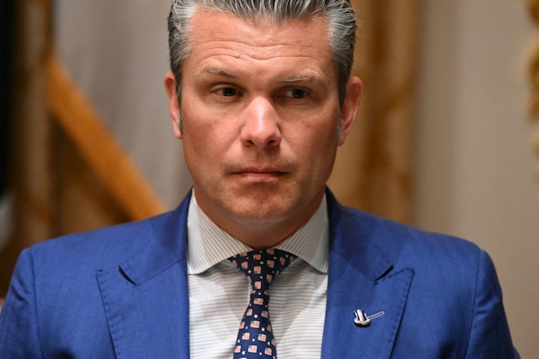 Defense Secretary Pete Hegseth sits during a meeting between Donald Trump and the Australian prime minister