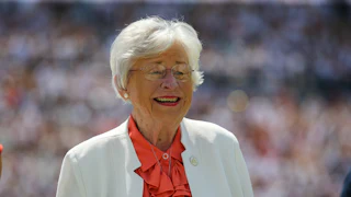 Alabama Governor Kay Ivey smiles during a football game