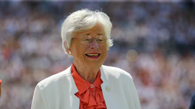 Alabama Governor Kay Ivey smiles during a football game
