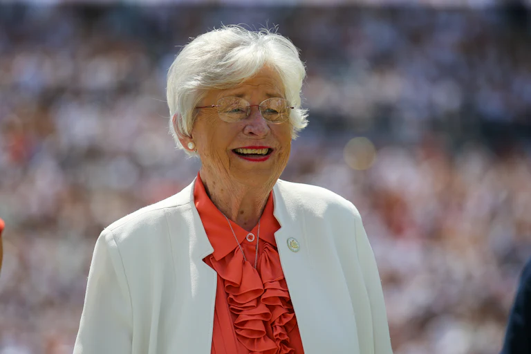 Alabama Governor Kay Ivey smiles during a football game