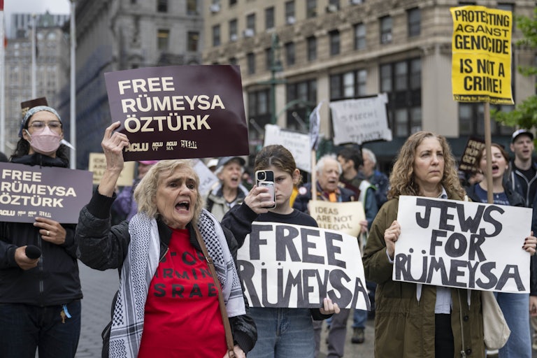 People hold up signs calling for the release of Rumeysa Ozturk at a protest in her support