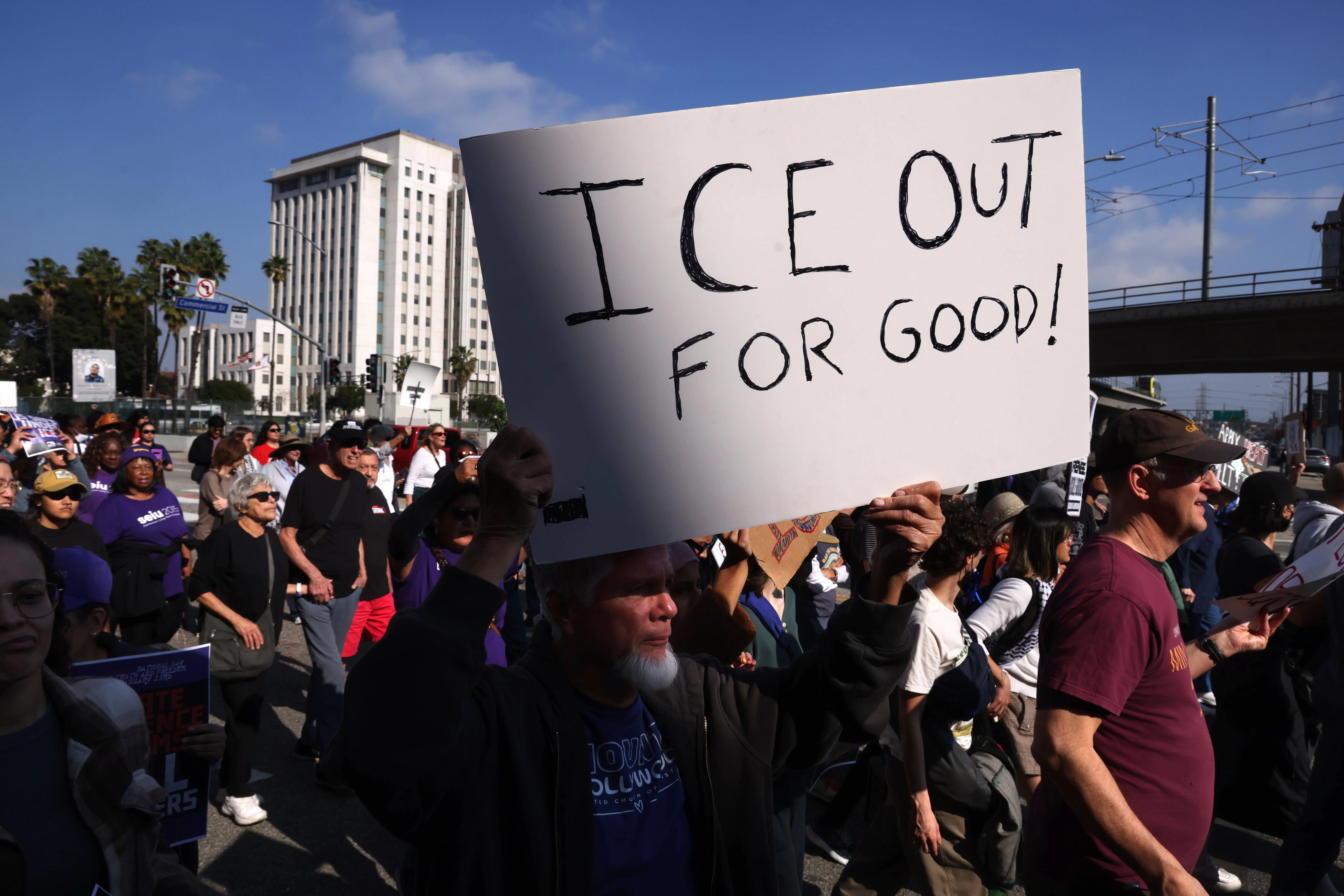A person holds up a sign that says, "ICE out for good!" during an anti-ICE protest in Los Angeles, California.