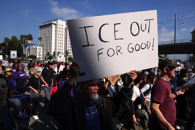 A person holds up a sign that says, "ICE out for good!" during an anti-ICE protest in Los Angeles, California.