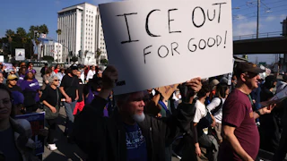 A person holds up a sign that says, "ICE out for good!" during an anti-ICE protest in Los Angeles, California.