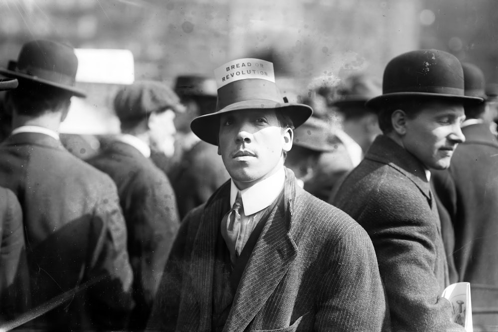 A man wearing a hat with a card that reads 'Bread Or Revolution' during a rally in New York's Union Square, April 1914.