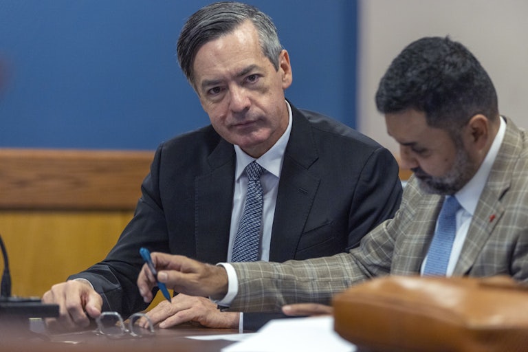 Kenneth Chesebro looks into the camera and smiles at court.