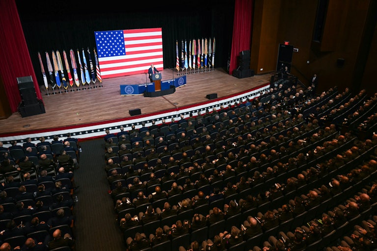Donald Trump spreaks in a auditorium full of military leaders.
