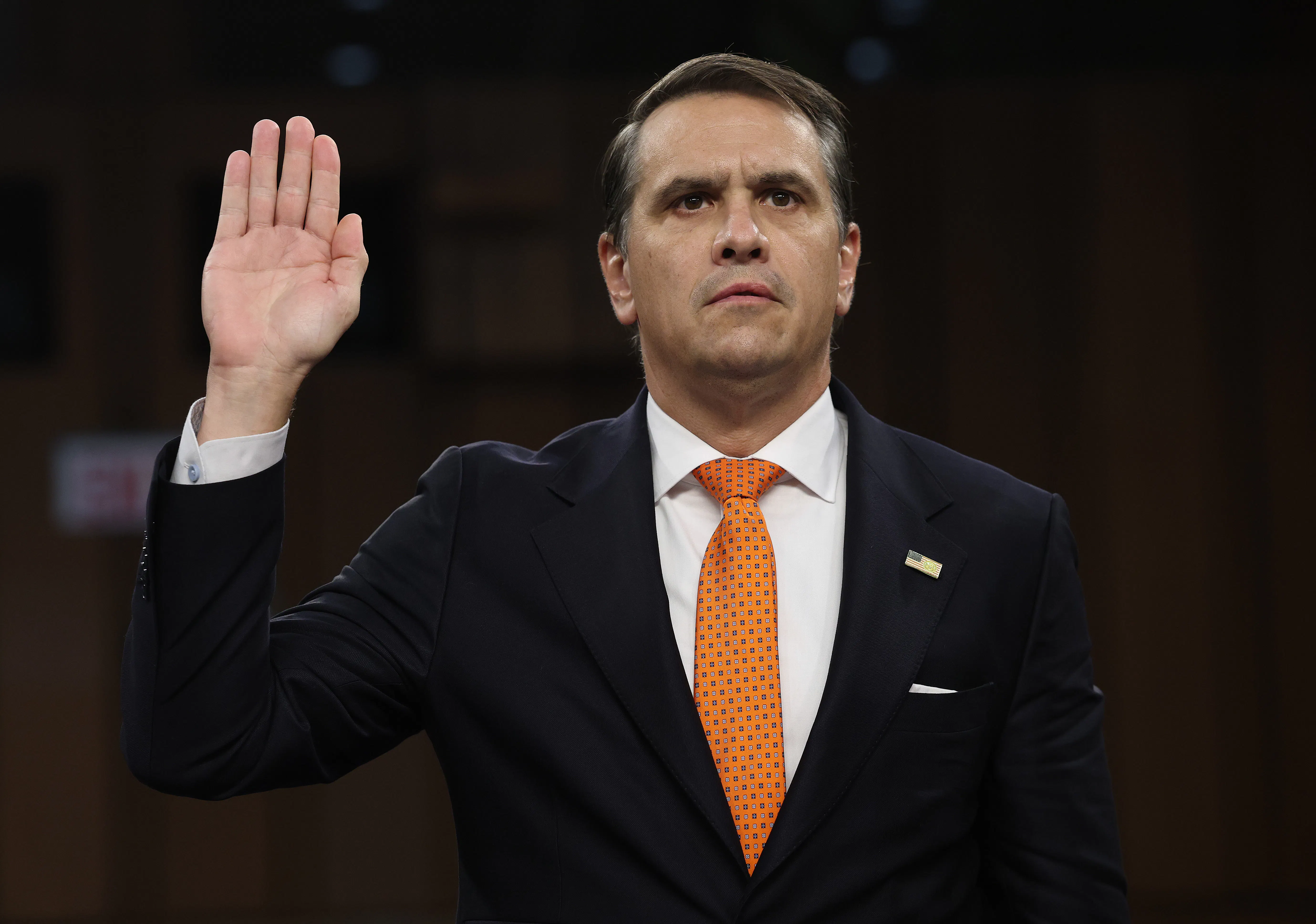 Acting Attorney General Todd Blanche holds his right hand up as he gets sworn in at his confirmation hearing before the Senate Judiciary 