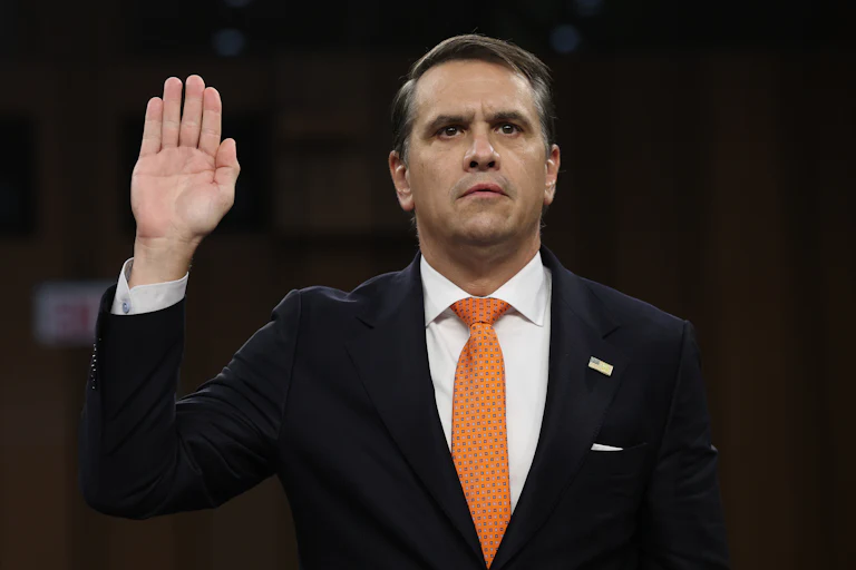 Acting Attorney General Todd Blanche holds his right hand up as he gets sworn in at his confirmation hearing before the Senate Judiciary