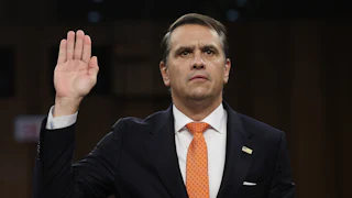 Acting Attorney General Todd Blanche holds his right hand up as he gets sworn in at his confirmation hearing before the Senate Judiciary