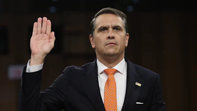 Acting Attorney General Todd Blanche holds his right hand up as he gets sworn in at his confirmation hearing before the Senate Judiciary