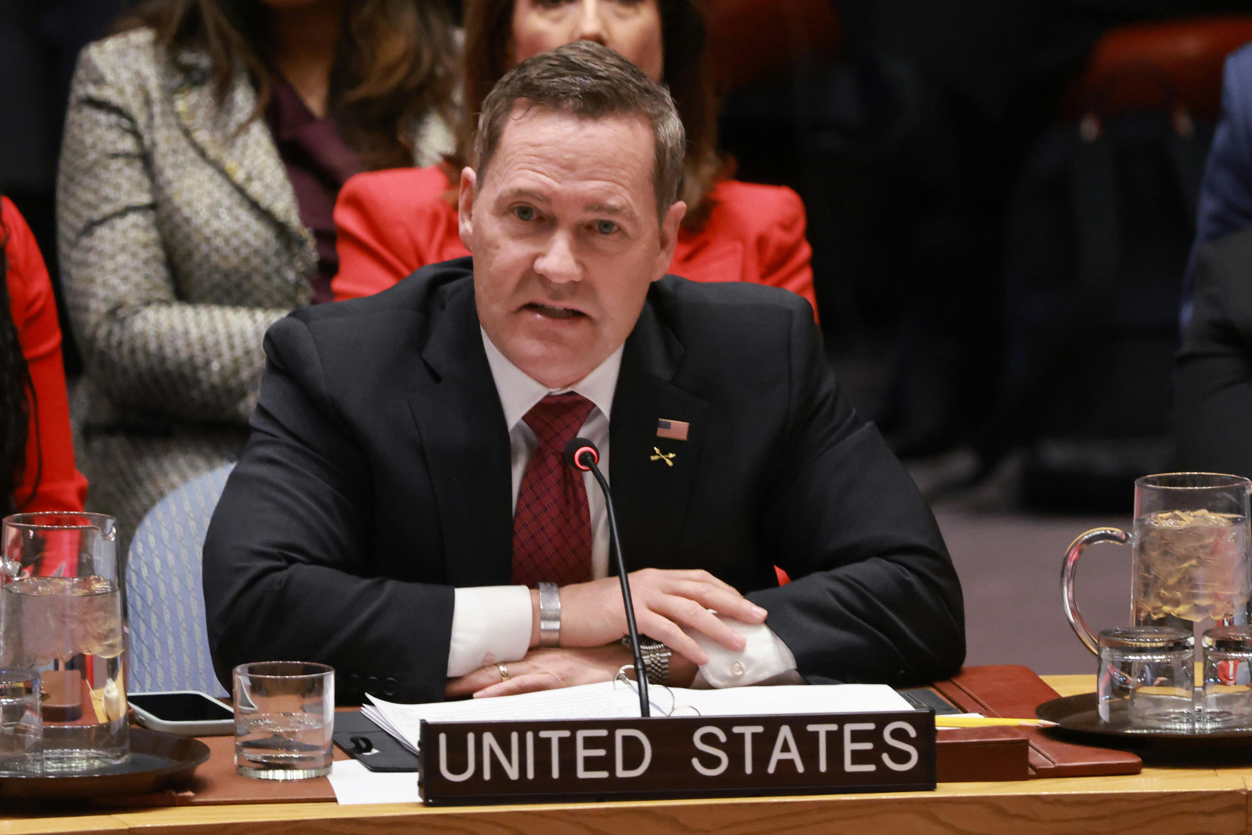 Mike Waltz speaks at the U.N. while seated behind the "United States" nameplate.