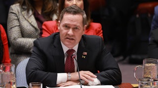 Mike Waltz speaks at the U.N. while seated behind the "United States" nameplate.