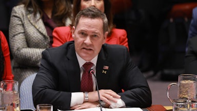 Mike Waltz speaks at the U.N. while seated behind the "United States" nameplate.