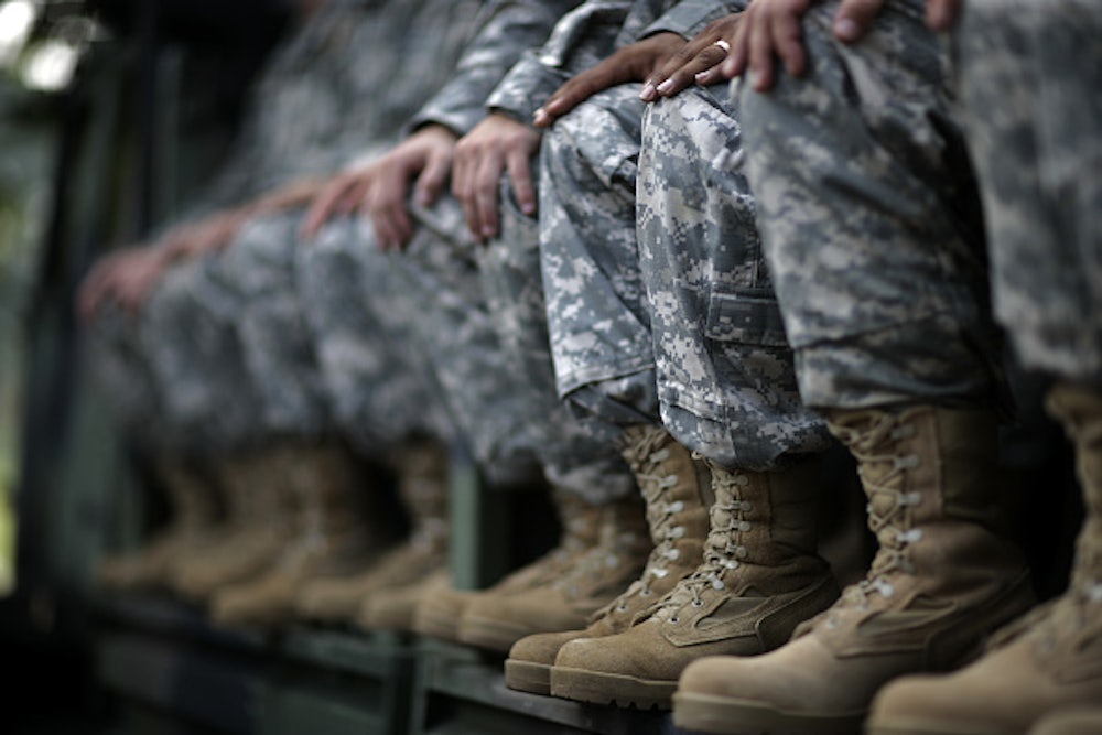 A view of the combat boots of U.S. troops as they listen to U.S. President George W Bush speak on Independence Day 2006 at Fort Bragg, North Carolin