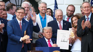 Donald Trump, joined by Republican lawmakers, signs the One Big Beautiful Bill Act into law on July 4, 2025.