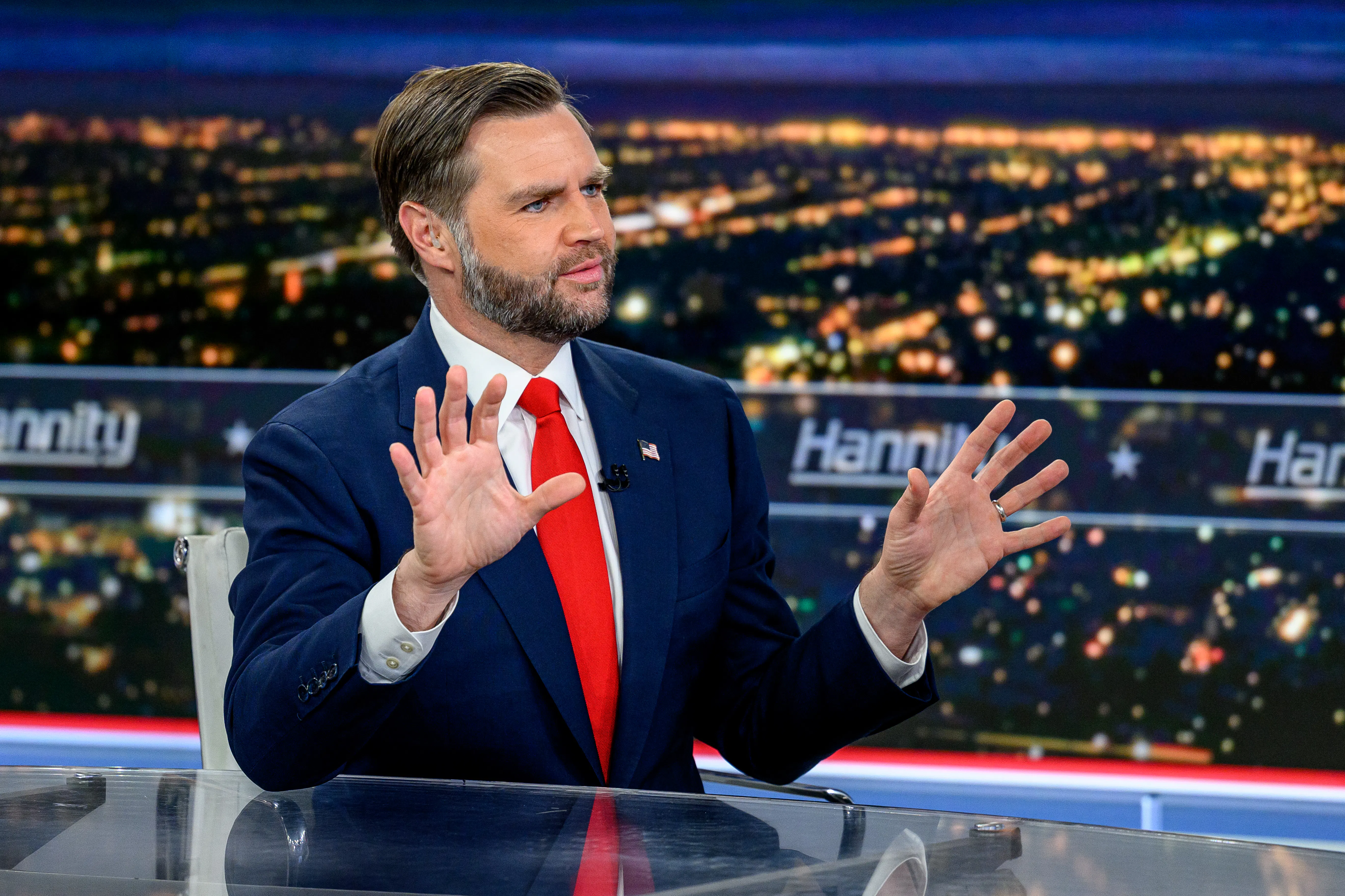 Vice President JD Vance holds up his hands while sitting on the set of Hannity