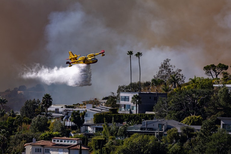 A Canadian Super Scooper drops water on the fire in Los Angeles