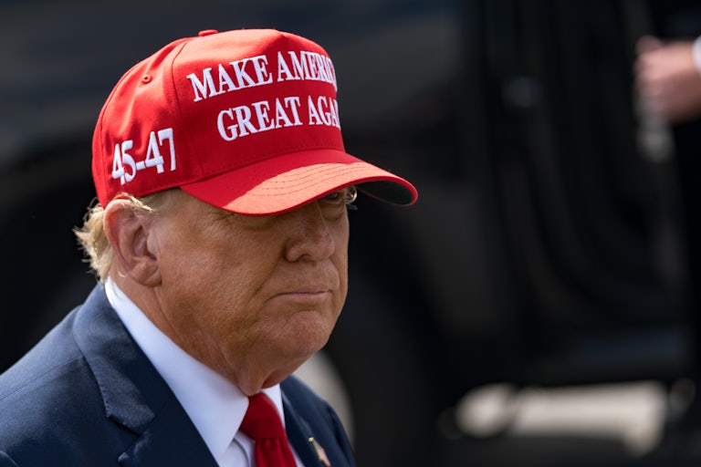 Donald Trump wears a MAGA hat