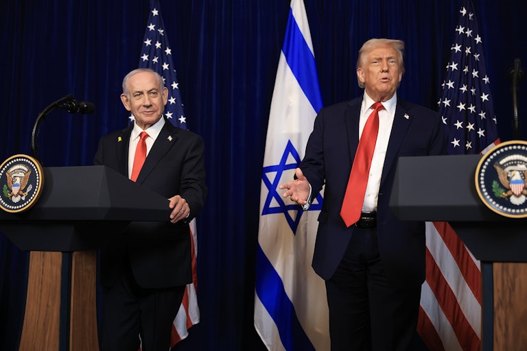 Israeli Prime Minister Benjamin Netanyahu and Donald Trump stand next to each other at podiums. Trump gestures and speaks.