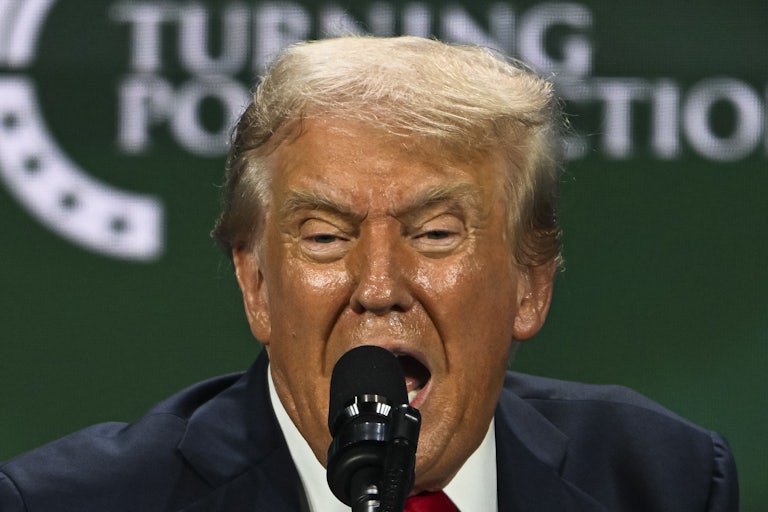 Donald Trump speaks into the microphone at a Turning Point USA event