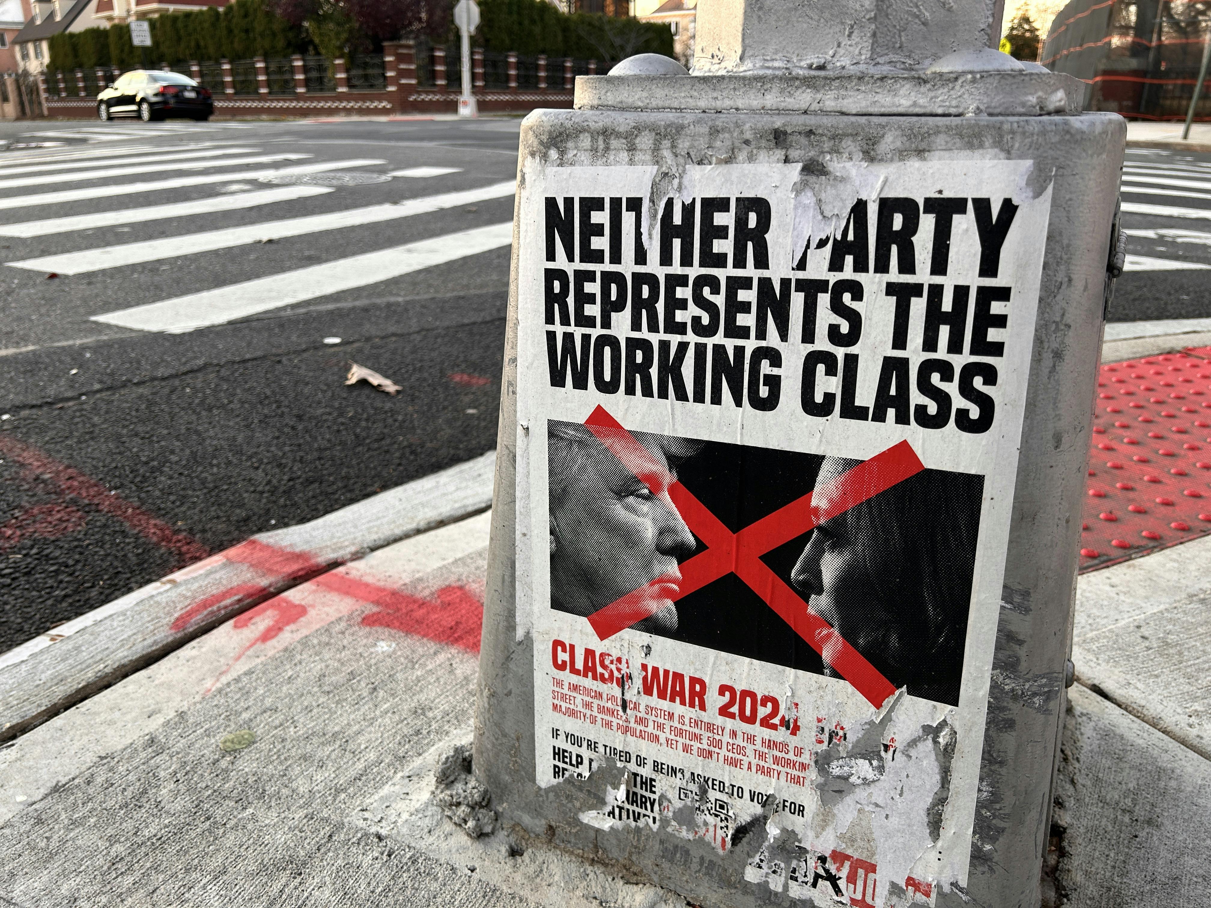 A poster reading "Neither Party represents the working Class" appears on a light pole in Queens, New York. 