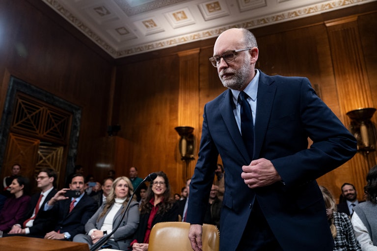 Russell Vought puts his hand on his suit as he prepares to sit for his Senate confirmation hearing for OMB director.